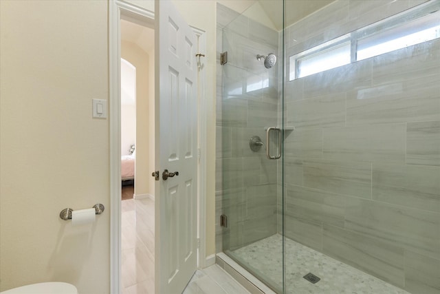 full bathroom with a shower stall and connected bathroom