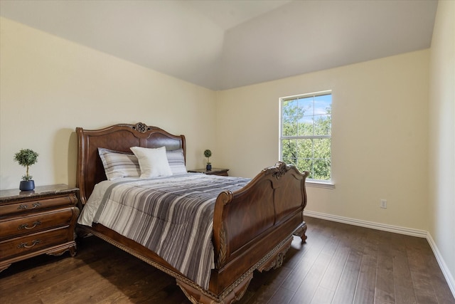 bedroom featuring dark wood-style floors, vaulted ceiling, and baseboards