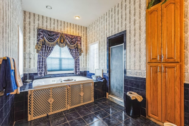 bathroom featuring tiled bath and tile patterned flooring