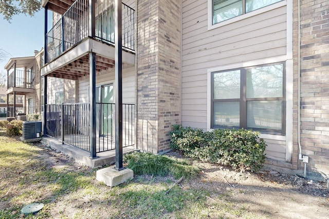 view of side of home with central AC