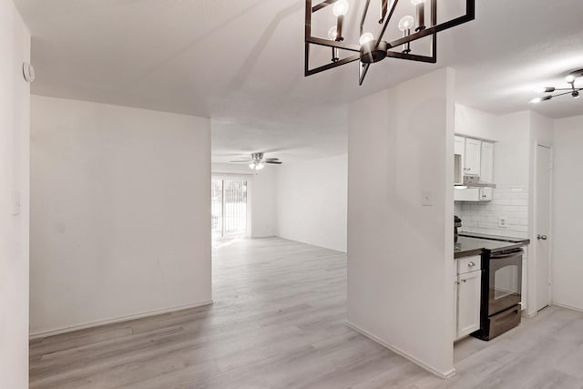 interior space featuring light hardwood / wood-style floors and an inviting chandelier