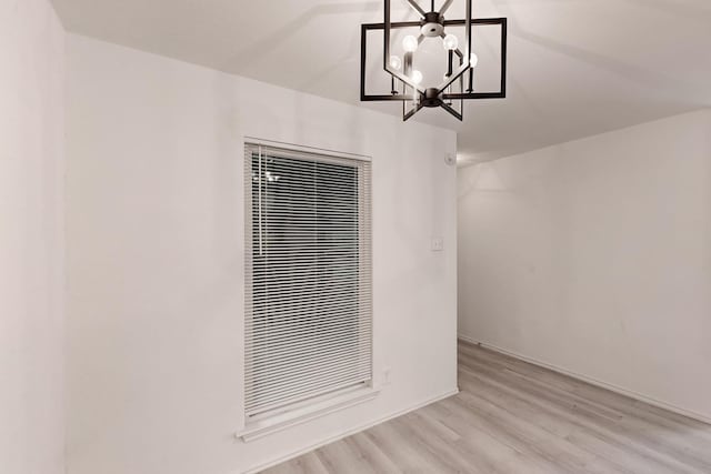 interior space with a chandelier and light hardwood / wood-style floors