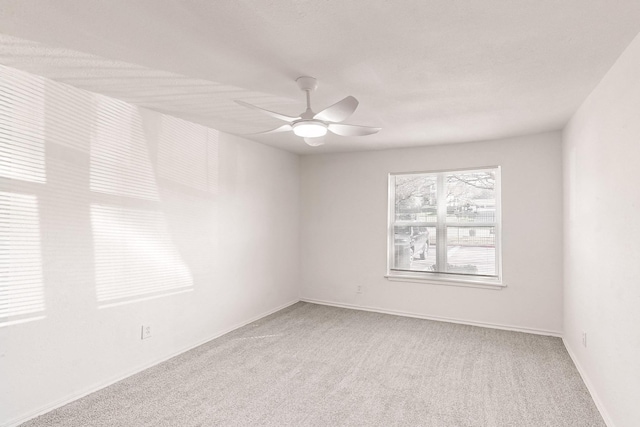 unfurnished room featuring ceiling fan and carpet floors