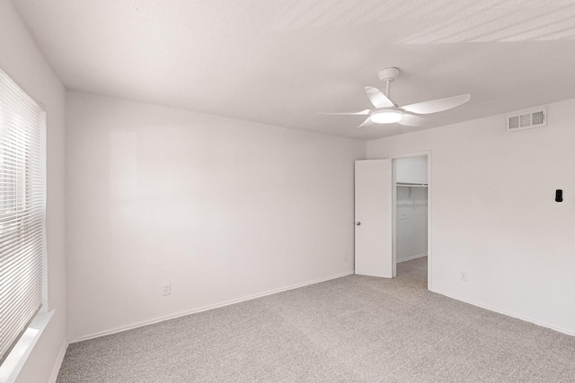 empty room with light carpet and ceiling fan