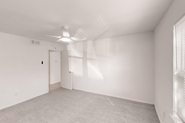 unfurnished room featuring ceiling fan and carpet floors