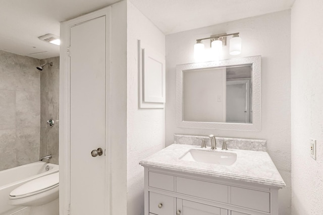 full bathroom featuring vanity, toilet, and tiled shower / bath combo