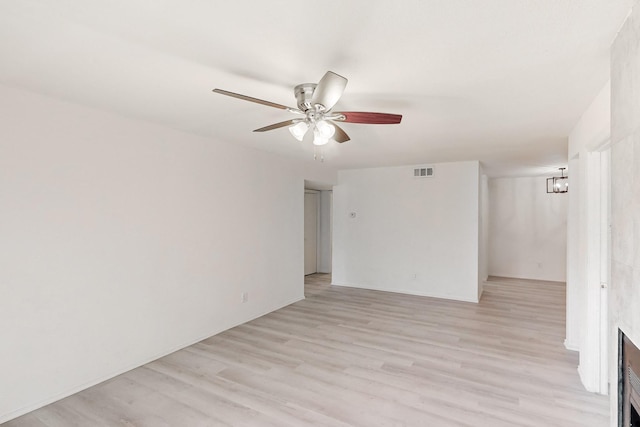 unfurnished room featuring light hardwood / wood-style flooring and ceiling fan