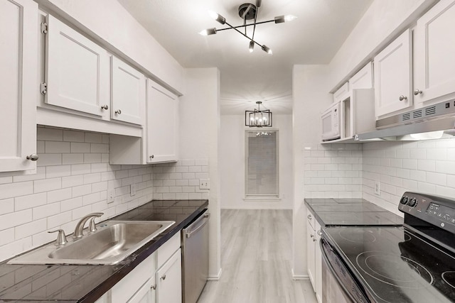 kitchen featuring light wood-type flooring, sink, electric range, dishwasher, and white cabinets