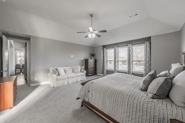 carpeted bedroom with ceiling fan, multiple windows, and lofted ceiling