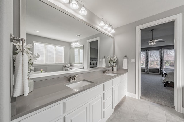 bathroom featuring ceiling fan, vanity, and plenty of natural light