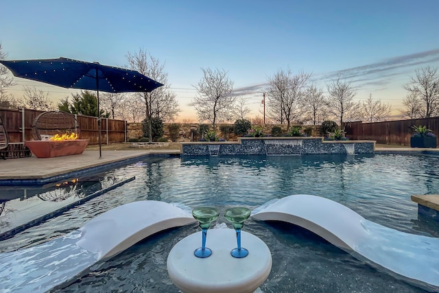 view of pool at dusk