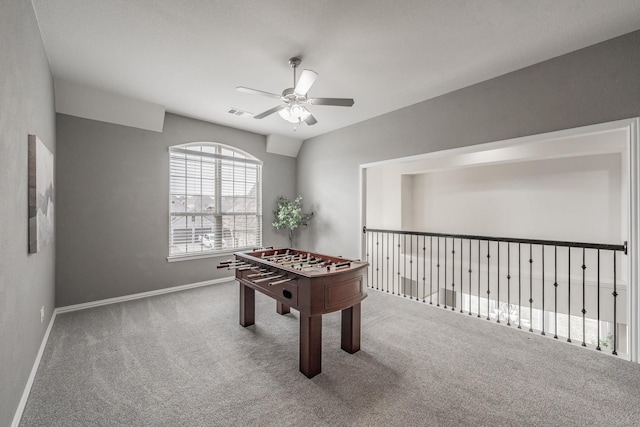 rec room with vaulted ceiling, ceiling fan, and carpet