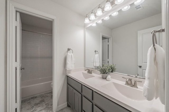 full bathroom with toilet, tiled shower / bath combo, and vanity