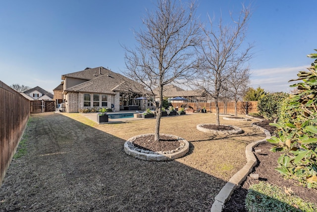 view of yard featuring a fenced in pool and a patio area