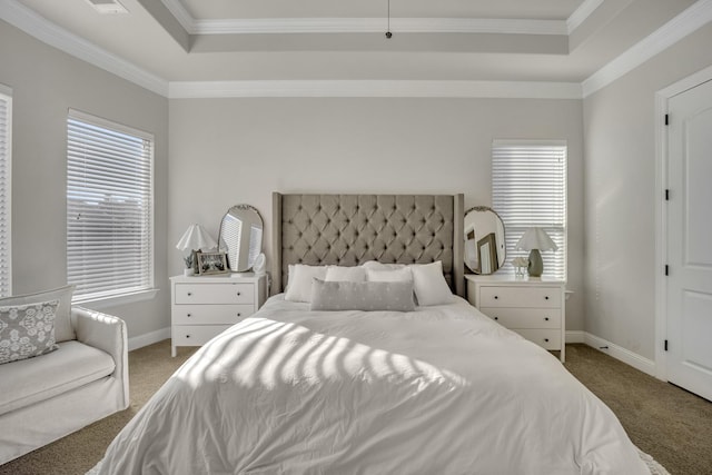 bedroom with a tray ceiling, carpet floors, and ornamental molding