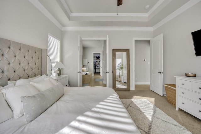 bedroom featuring a tray ceiling, ornamental molding, and light colored carpet