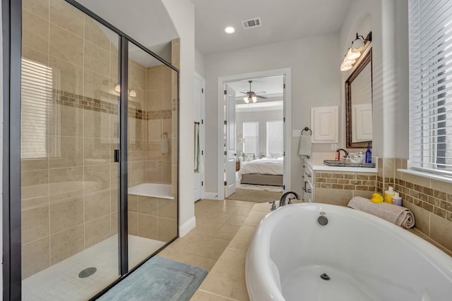 bathroom with ceiling fan, vanity, shower with separate bathtub, and tile patterned flooring