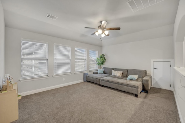 carpeted living room with ceiling fan and lofted ceiling