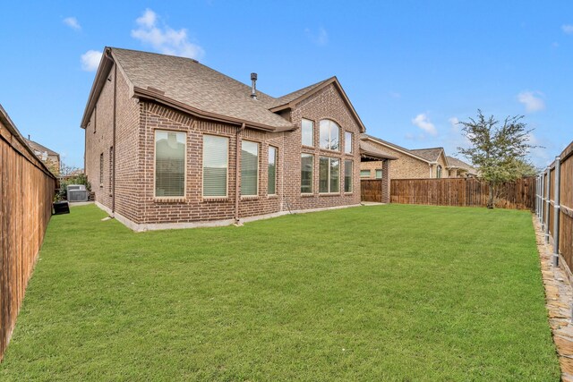 rear view of property featuring a lawn