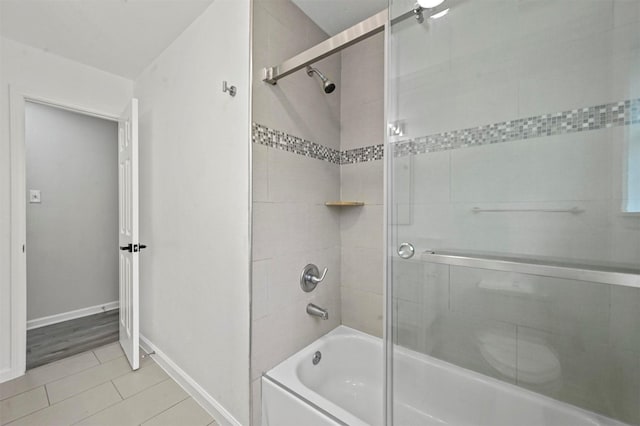 bathroom featuring tile patterned floors and enclosed tub / shower combo