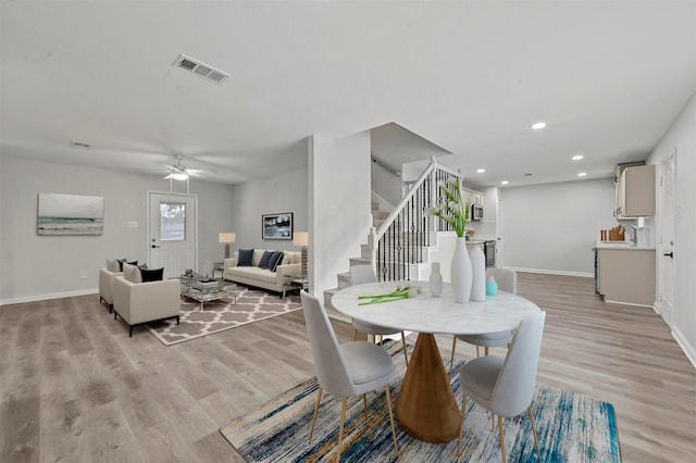 dining room with light hardwood / wood-style floors and ceiling fan