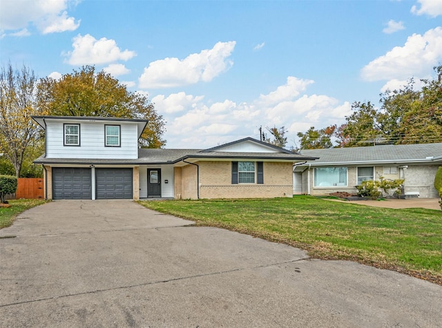 view of front of house with a front yard and a garage