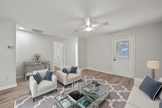 living room featuring ceiling fan and light wood-type flooring