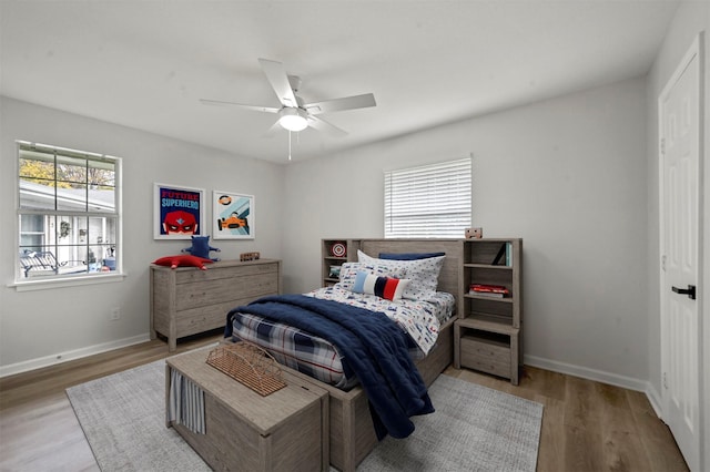 bedroom with hardwood / wood-style floors and ceiling fan