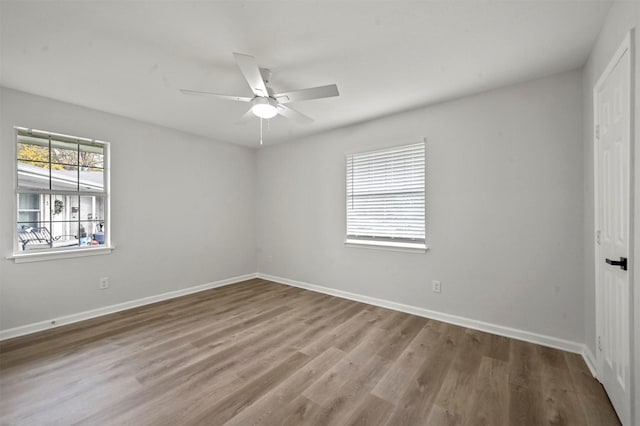 empty room with hardwood / wood-style flooring and ceiling fan