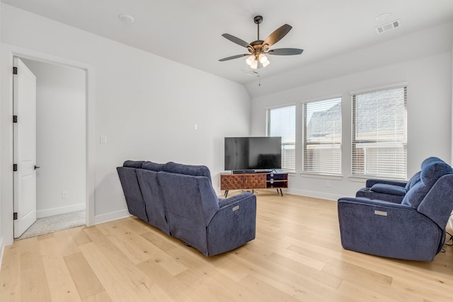 living room with ceiling fan, light wood-type flooring, and lofted ceiling