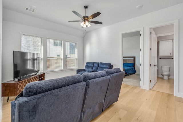 living room with ceiling fan and light hardwood / wood-style flooring