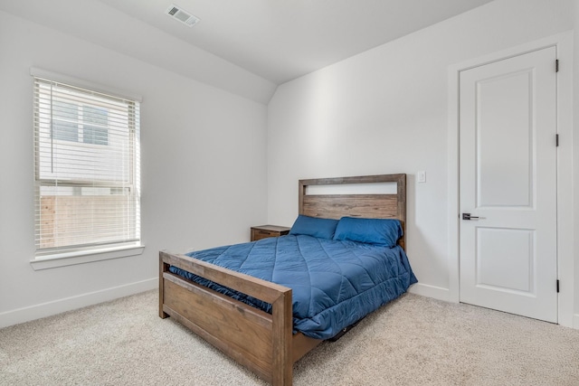 bedroom with light carpet and vaulted ceiling