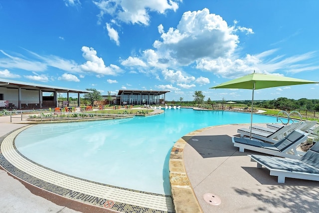 view of swimming pool with a patio