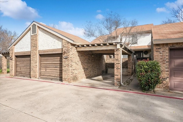 view of front of property featuring a garage and a carport