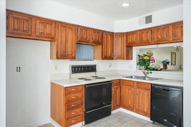 kitchen featuring electric range, dishwasher, light tile patterned flooring, and sink