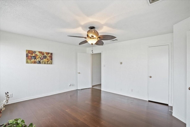 spare room with ceiling fan and dark wood-type flooring