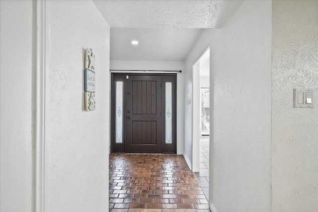 foyer entrance with a healthy amount of sunlight and a textured ceiling