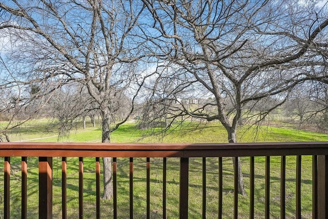 wooden deck featuring a lawn