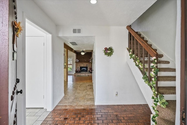 foyer entrance with a textured ceiling