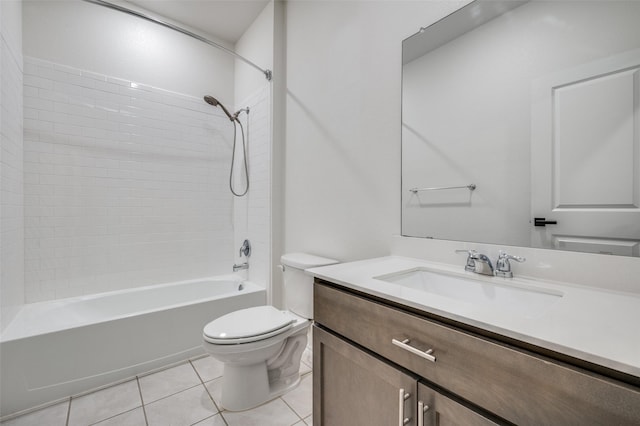 full bathroom featuring tile patterned flooring, vanity, tiled shower / bath, and toilet