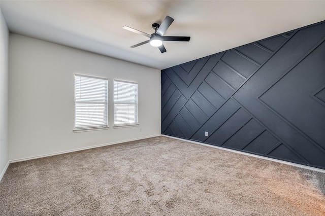 empty room with ceiling fan and carpet flooring