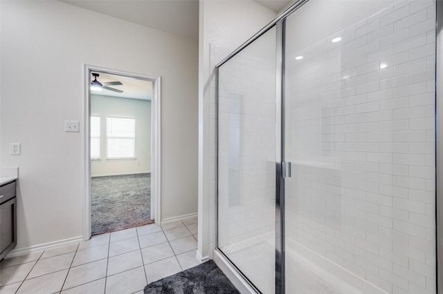 bathroom with tile patterned flooring, vanity, and walk in shower