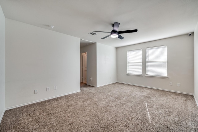 carpeted empty room featuring ceiling fan