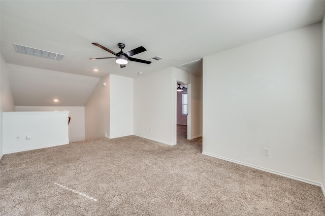 interior space with lofted ceiling, ceiling fan, and carpet