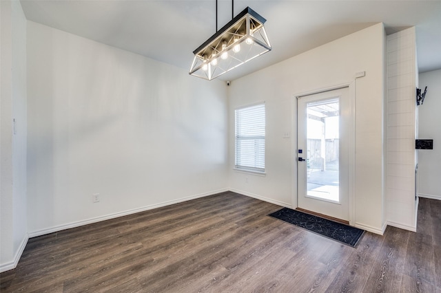 doorway with dark wood-type flooring