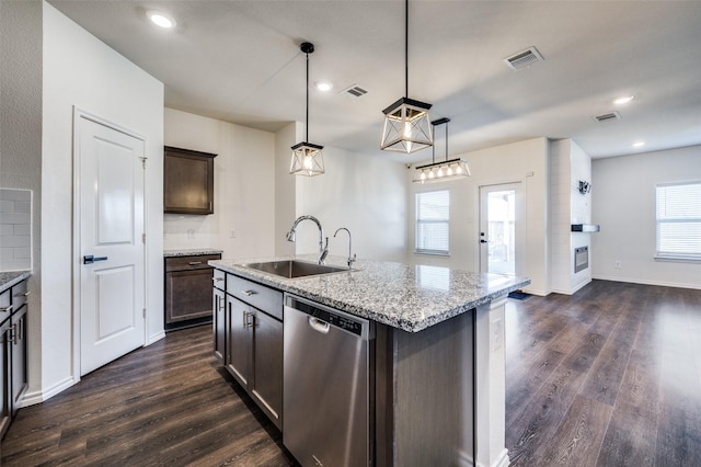 kitchen featuring sink, decorative light fixtures, dark brown cabinets, dishwasher, and an island with sink