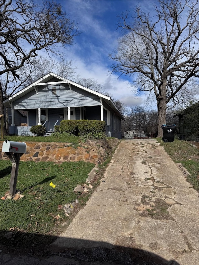 view of property exterior featuring a yard and a porch