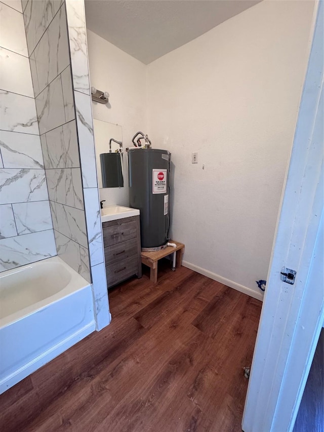 bathroom featuring electric water heater, hardwood / wood-style floors, and vanity