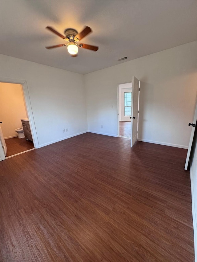 spare room with ceiling fan and dark hardwood / wood-style flooring