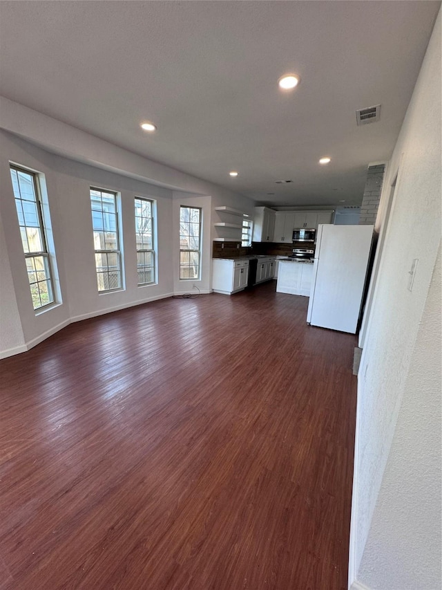 unfurnished living room featuring dark hardwood / wood-style flooring